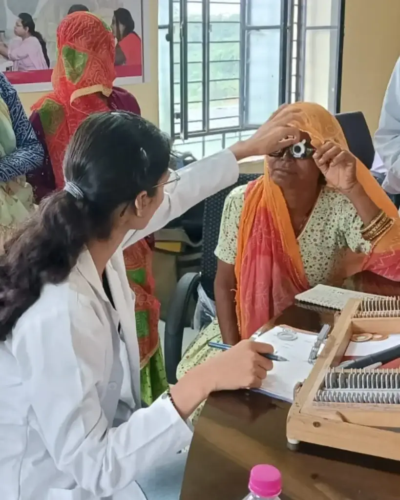 doctor carrying out eyesight test in a rural village of India
