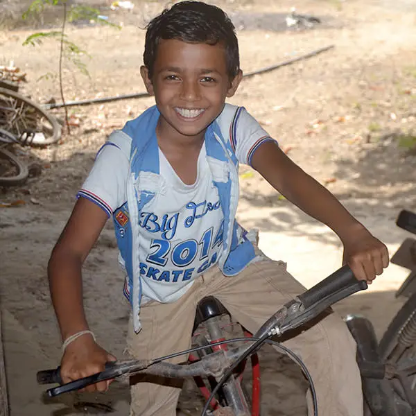 Boy smiling on a bike